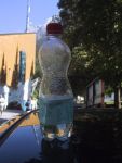 Water bottle deformed from pressure change, back on the ground